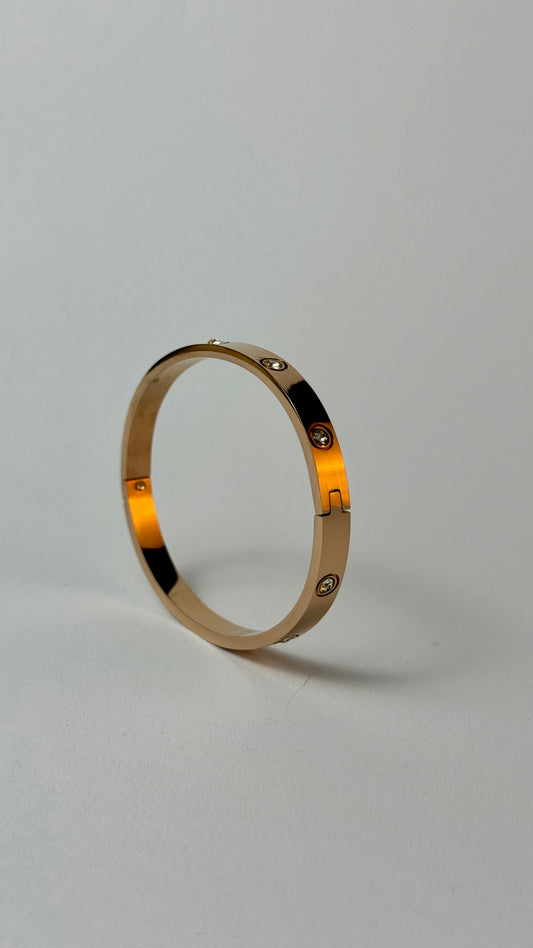 Gold bracelet with embedded zircon stones