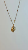 Necklace with a small pendant on a light gray background