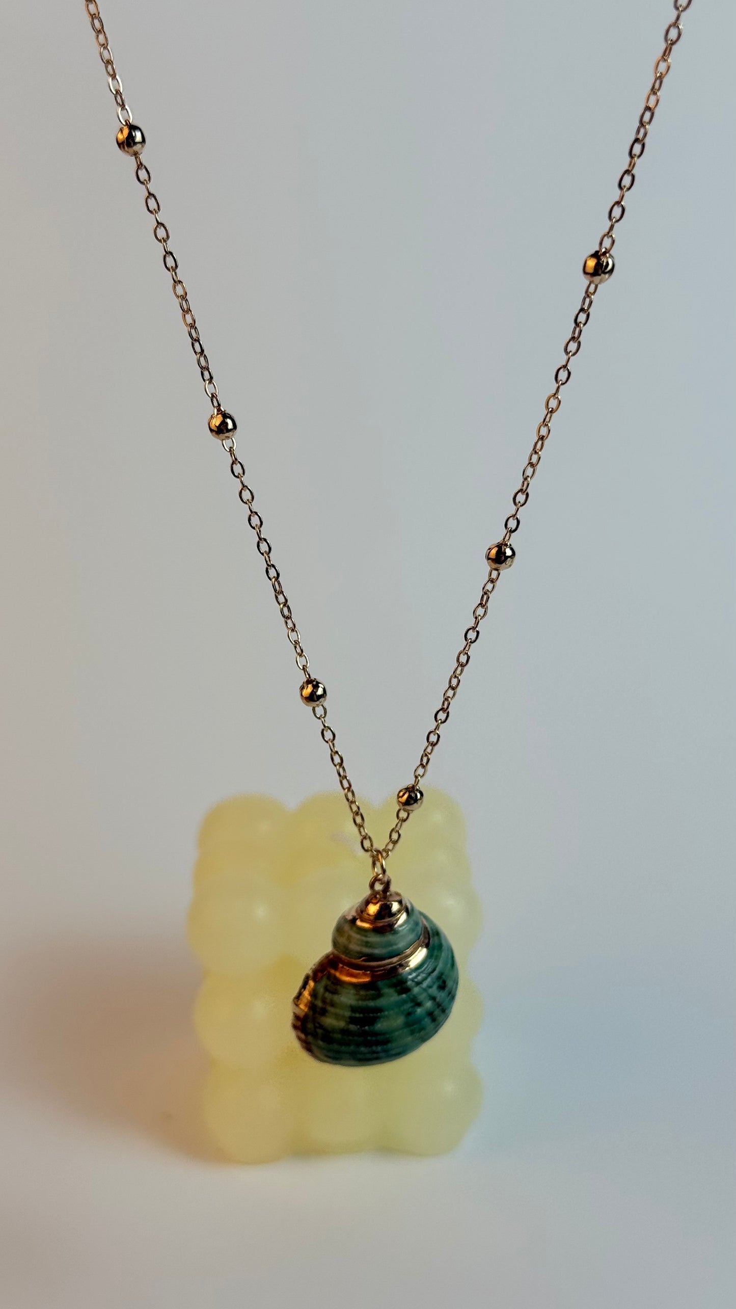Necklace with a pendant on a light gray background