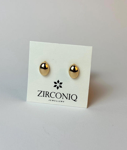 Gold earrings on a Zirconiq branded card against a light gray background