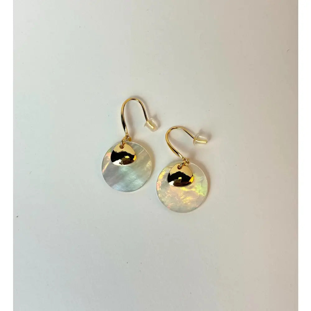 Gold earrings with round, light-colored stones on a white background