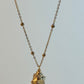 Necklace with a small pendant on a light gray background
