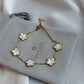 Gold bracelet with floral designs on a gray jewelry box