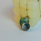 Necklace with a green shell pendant on a light background
