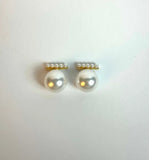 Pair of pearl earrings with gold accents on a white background