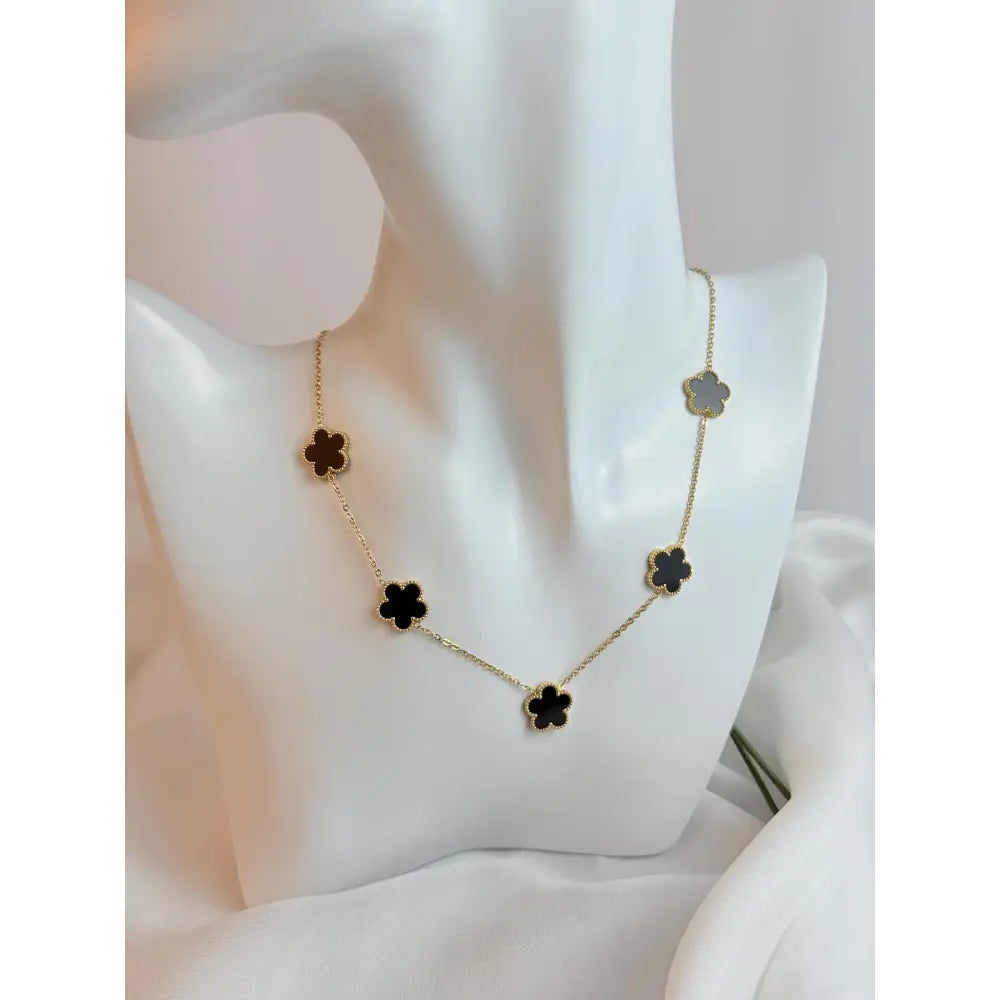 Necklace with black flower pendants on a white mannequin bust