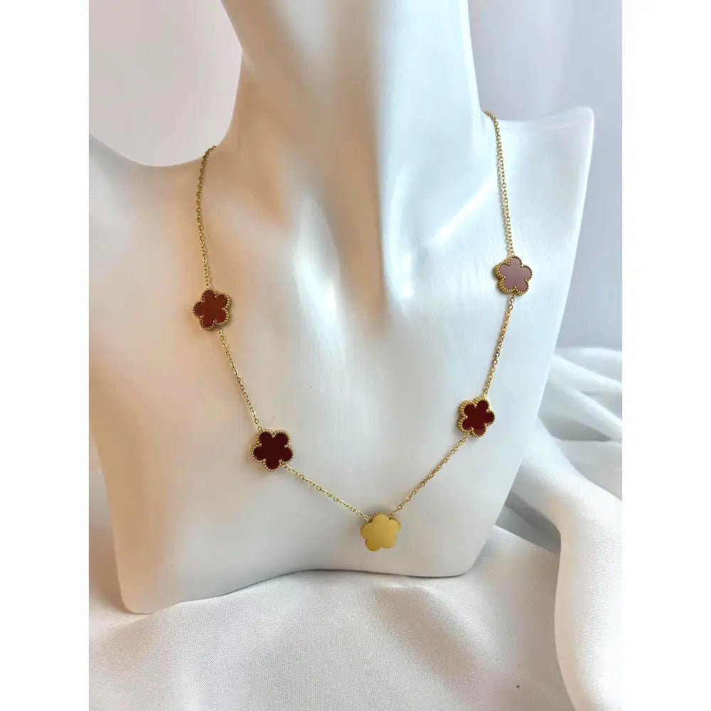 Necklace with flower-shaped pendants on a mannequin bust.