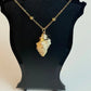 Necklace with a stone pendant on a black stand against a white background